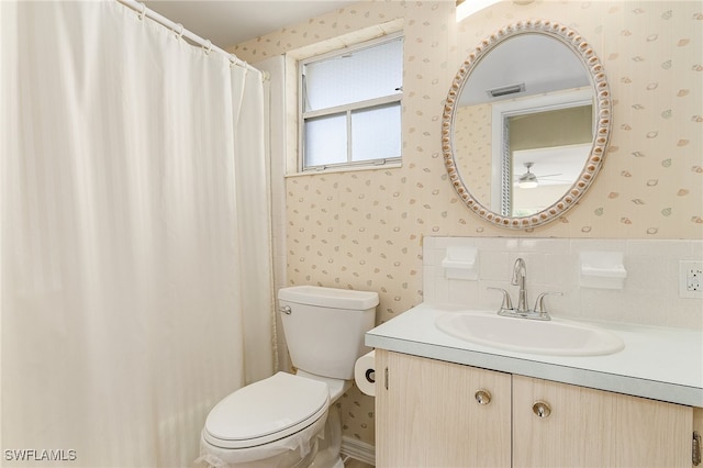 bathroom with vanity, ceiling fan, and toilet