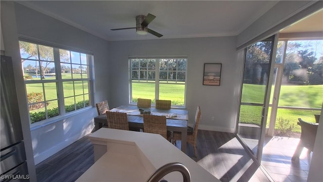 sunroom / solarium featuring plenty of natural light and ceiling fan