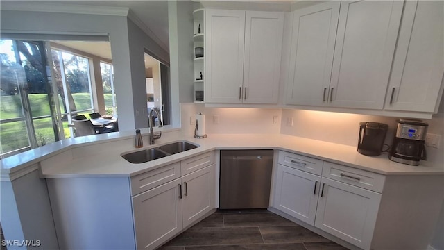 kitchen featuring dishwasher, white cabinetry, sink, and kitchen peninsula