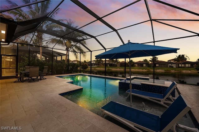 pool with glass enclosure, a patio, a hot tub, and a water view