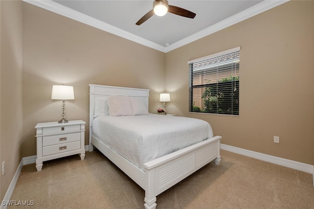 bedroom featuring baseboards, ceiling fan, crown molding, and light colored carpet