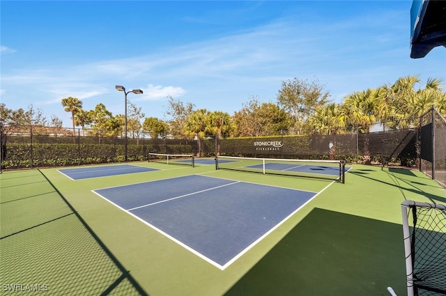 view of sport court featuring community basketball court and fence