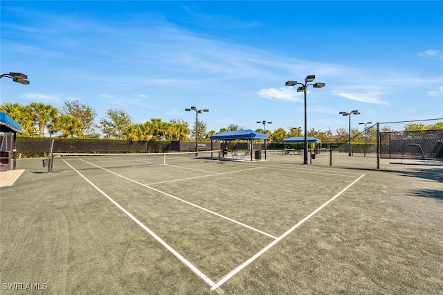 view of tennis court with fence