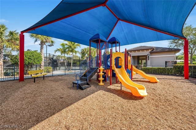 community jungle gym featuring fence