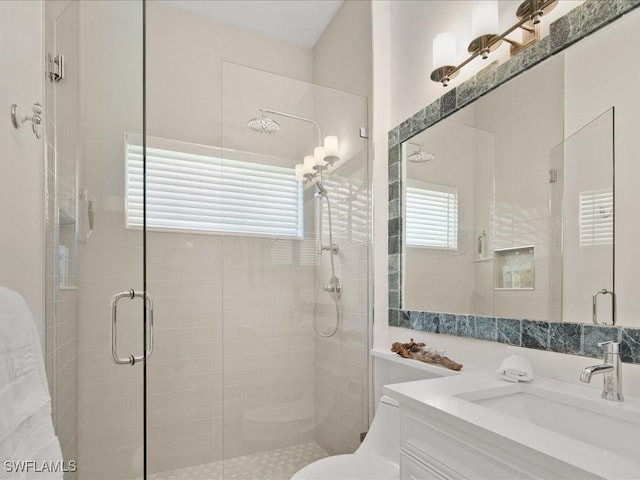 bathroom featuring a stall shower, vanity, and toilet