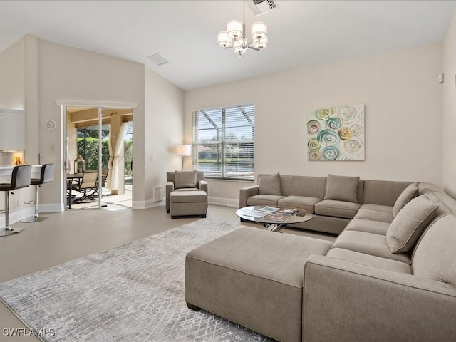 living room with visible vents, a chandelier, vaulted ceiling, and a wealth of natural light