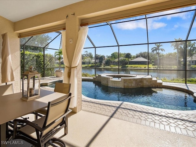 outdoor pool with a patio area, glass enclosure, an in ground hot tub, and a water view