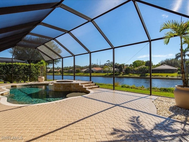 exterior space with glass enclosure, a patio area, and a water view