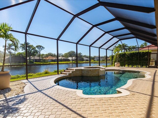 view of pool with a water view, glass enclosure, a pool with connected hot tub, and a patio