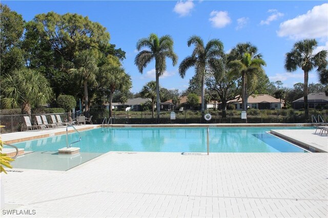 community pool featuring a patio area and fence