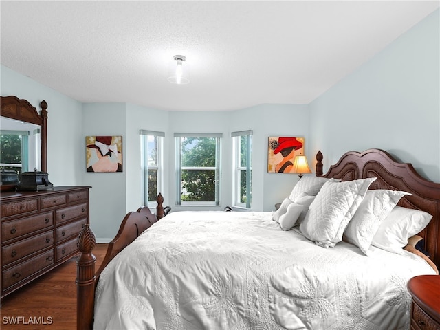 bedroom with dark hardwood / wood-style floors