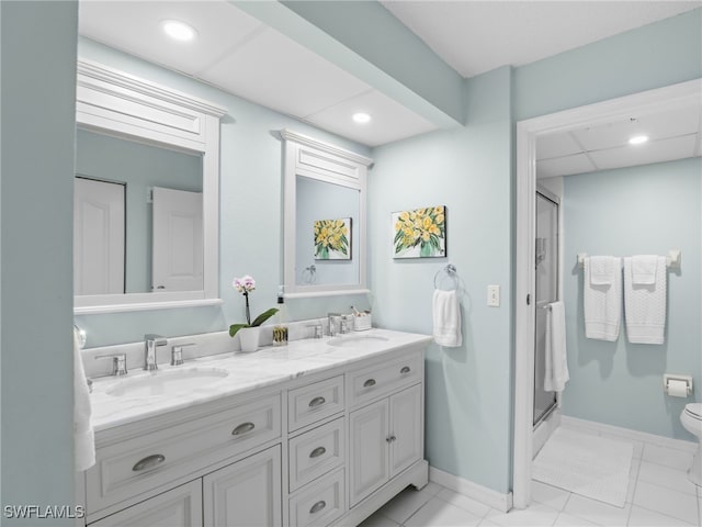 bathroom featuring toilet, an enclosed shower, tile patterned floors, and vanity