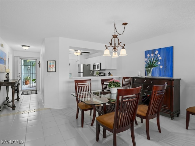 tiled dining space with ceiling fan