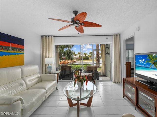 tiled living room with a healthy amount of sunlight, a textured ceiling, and ceiling fan