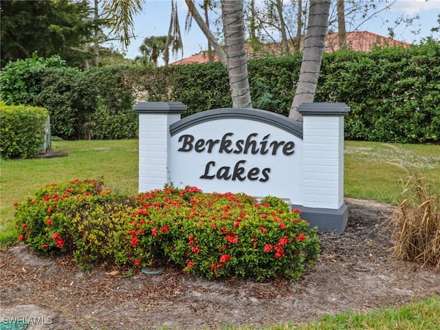 community / neighborhood sign with a lawn