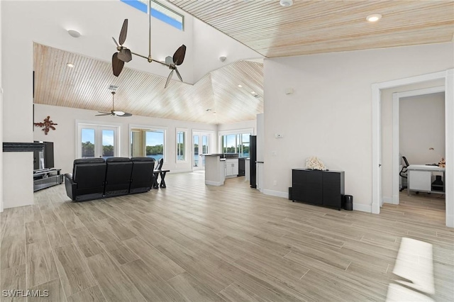 living room featuring ceiling fan, light hardwood / wood-style flooring, and high vaulted ceiling