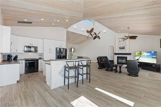 kitchen featuring black appliances, ceiling fan, white cabinets, and decorative backsplash