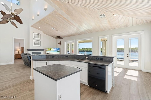 kitchen featuring white cabinetry, sink, french doors, black dishwasher, and a kitchen island