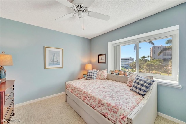 bedroom with a textured ceiling and ceiling fan