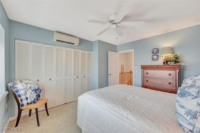 bedroom with an AC wall unit, ceiling fan, and a closet