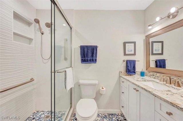 bathroom featuring a shower with shower door, vanity, and toilet