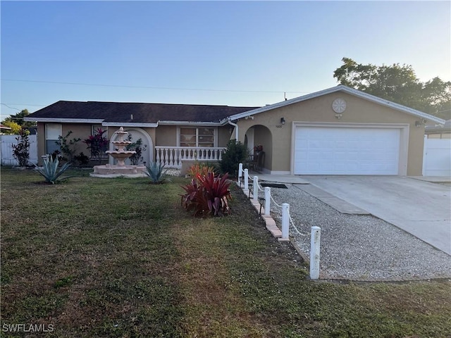 ranch-style house with a garage and a front lawn