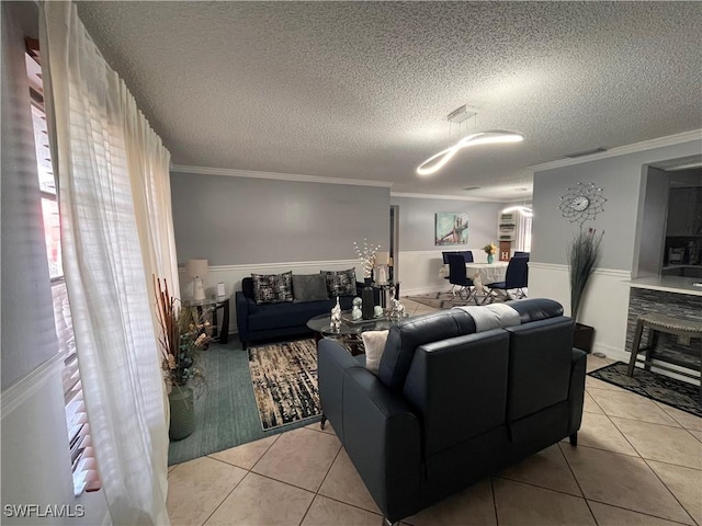 tiled living room featuring ornamental molding and a textured ceiling