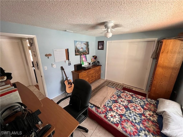 tiled office with ceiling fan and a textured ceiling