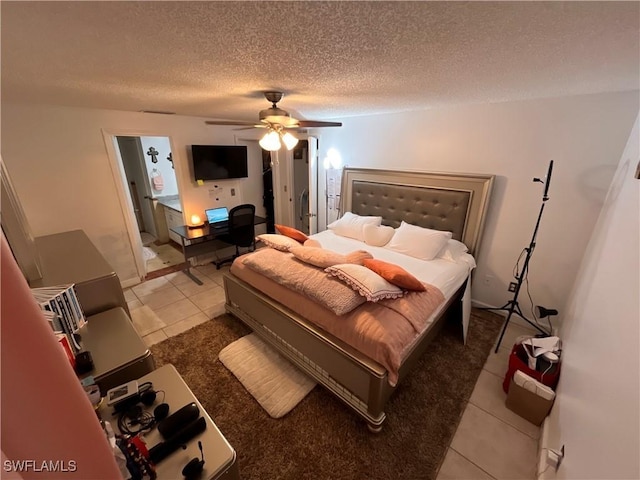 tiled bedroom featuring ceiling fan and a textured ceiling