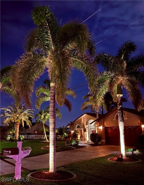 view of front of house with a garage and a front yard