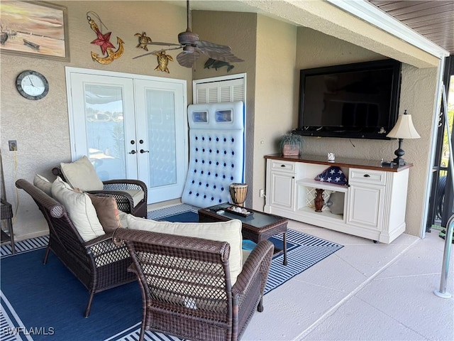 living room featuring ceiling fan and french doors