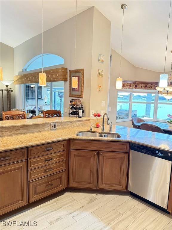 kitchen featuring sink, stainless steel dishwasher, and decorative light fixtures