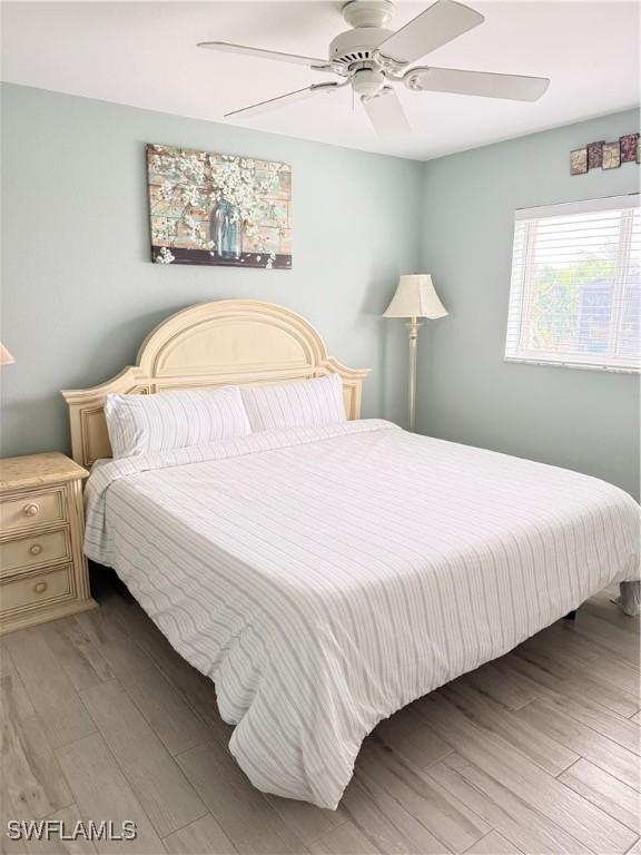 bedroom featuring hardwood / wood-style flooring and ceiling fan