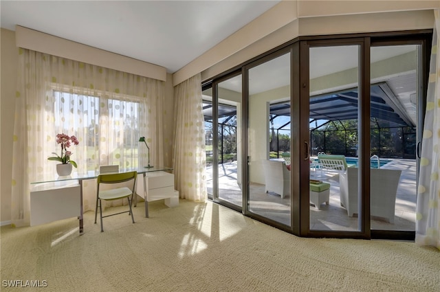 doorway to outside featuring carpet floors and a healthy amount of sunlight