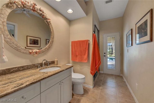 bathroom with ceiling fan, tile patterned flooring, vanity, and toilet