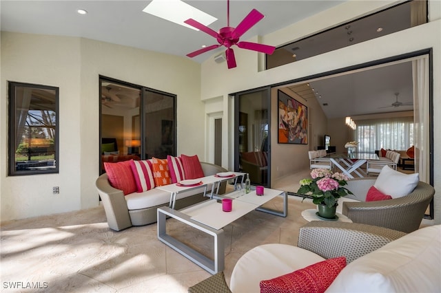 view of patio / terrace with ceiling fan and an outdoor living space