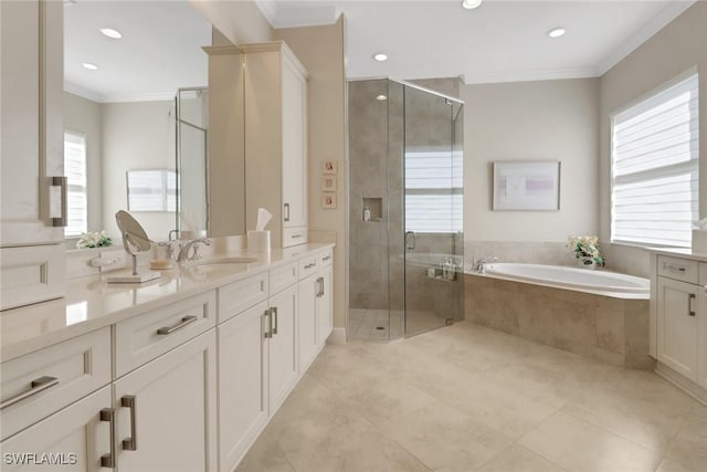 full bathroom with ornamental molding, plenty of natural light, vanity, and a bath