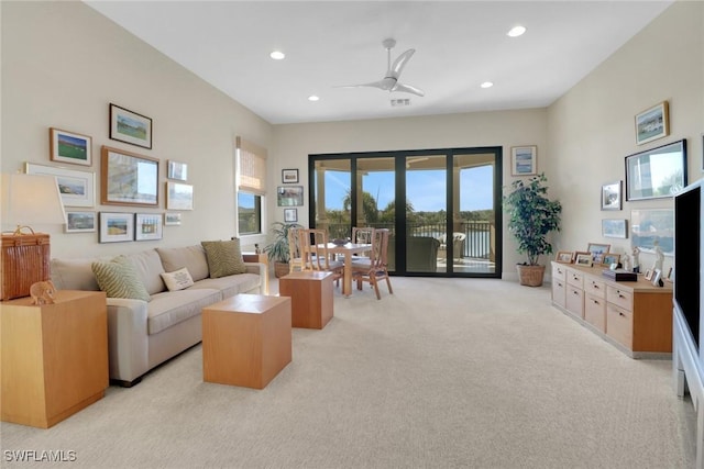 living area featuring a ceiling fan, recessed lighting, light carpet, and visible vents