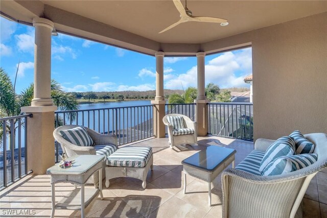 view of patio / terrace featuring ceiling fan, a balcony, and a water view