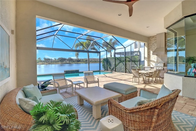 view of patio / terrace featuring an outdoor kitchen, a water view, a grill, outdoor lounge area, and outdoor dining space