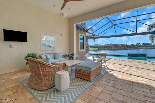 view of patio / terrace featuring an outdoor pool, a lanai, a water view, and ceiling fan