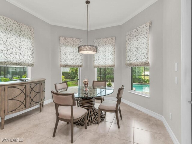 dining area with a wealth of natural light, crown molding, and light tile patterned flooring