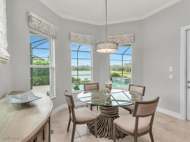 tiled dining space featuring ornamental molding and a water view