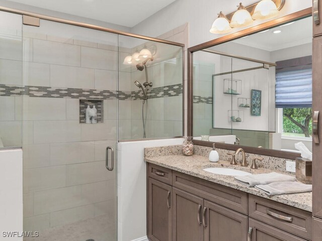 bathroom featuring an enclosed shower and vanity