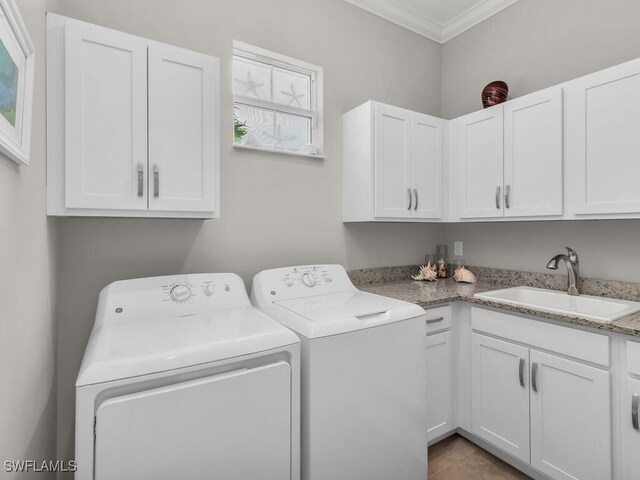 laundry room with independent washer and dryer, sink, ornamental molding, and cabinets