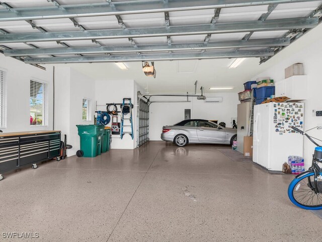 garage with a garage door opener and white fridge