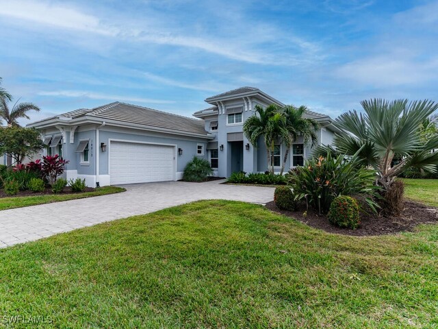 view of front of property with a front lawn and a garage