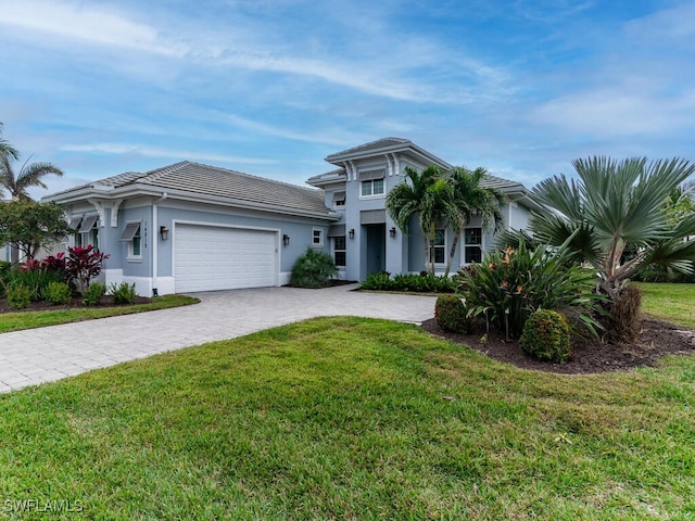 view of front facade featuring a garage and a front lawn