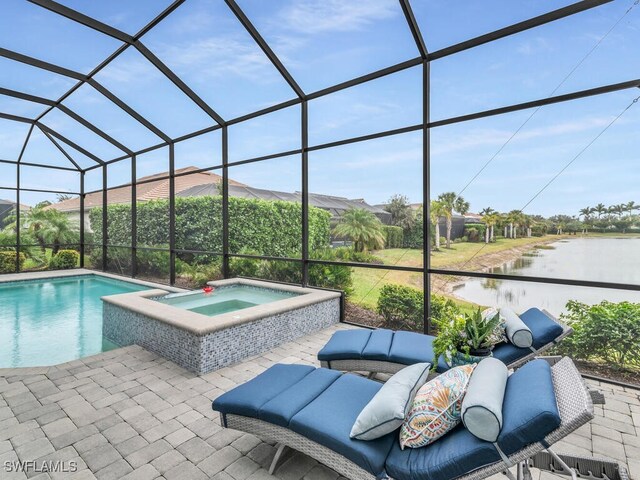 view of pool with a water view, a patio area, a lanai, and an in ground hot tub