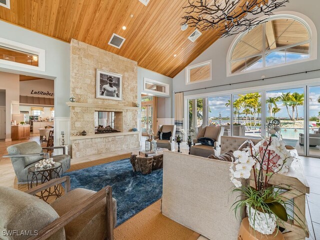 living room with high vaulted ceiling, wooden ceiling, and a fireplace